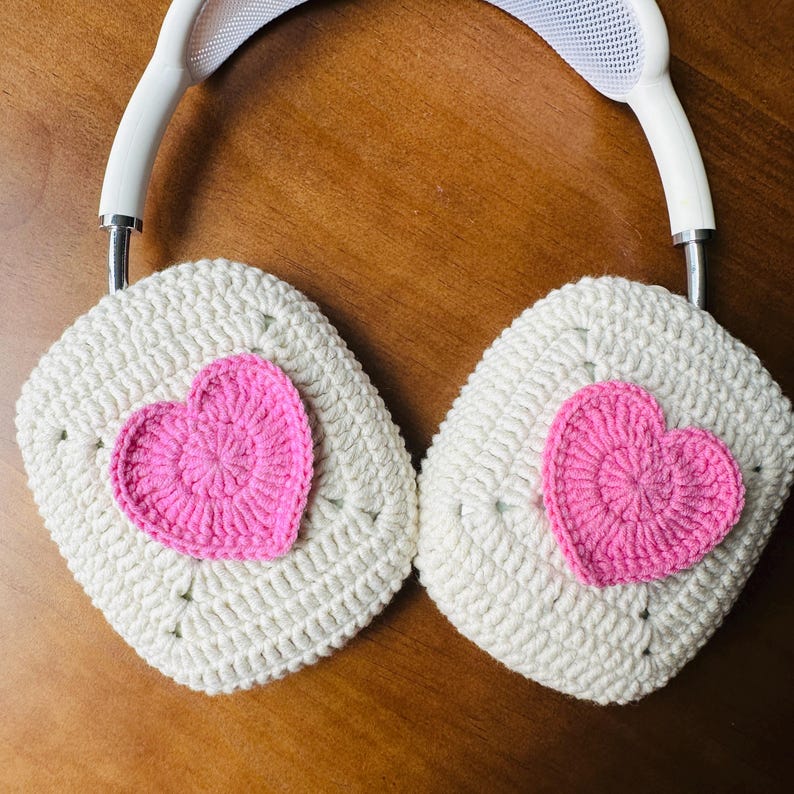 May include: White crocheted headphone covers with pink crocheted hearts.