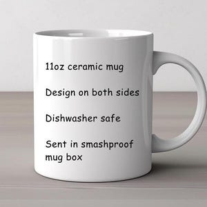 May include: A white ceramic mug with a curved handle. The mug is labeled as an 11oz mug with a design on both sides. The text also indicates the mug is dishwasher safe and sent in a smashproof mug box.
