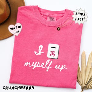 comfort colors crunchberry pink mahjong shirt with bold Crak tile graphic and funny quote, eye catching gift for mahjong lovers, perfect for girls night, group outfits, or fun statement shirts