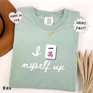 comfort colors bay green mahjong shirt featuring Crak tile and “I crack myself up” pun, cozy lifestyle tee for mahjong lovers, perfect for relaxing, social game nights, and hobby outfits