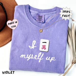 comfort colors violet mahjong shirt with Crak tile humor design, trendy and fun tee for mahjong lovers, ideal for birthdays, holidays, or matching group outfits