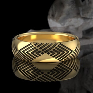 May include: A gold ring with a geometric pattern. The ring has a polished, reflective surface and a detailed design of interlocking shapes. The ring is displayed on a reflective surface, creating a mirrored effect. The ring is a piece of jewelry.