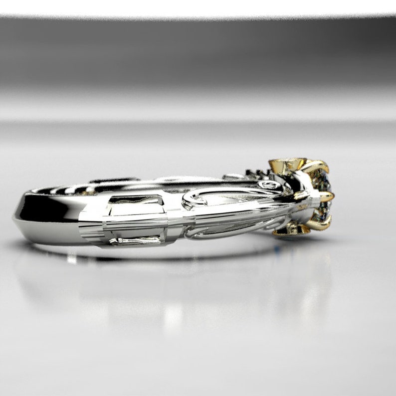 May include: A silver and gold engagement ring with a large center stone and smaller stones on the band. The ring has a detailed design with intricate carvings.