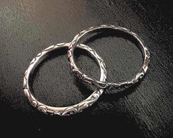 Sterling silver band ring with vine pattern, optionally with patina.