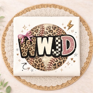 May include: A white square with the text "WWD" in a baseball-themed design. The "W" is leopard print, the "E" is checkered, and the "D" is pink. A pink bow is on the left side. The background is a baseball with red stitching.