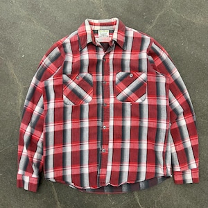 May include: Red, black and white plaid flannel shirt with long sleeves and a button-up front. The shirt has two chest pockets and a label that reads "Big Yank".