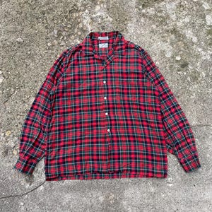 May include: A red, green and black plaid long-sleeved button-up shirt with a collared neckline.