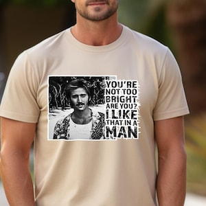Charming Ignorance Tee, Action Movie Graphic Shirt, Dr. Stanley Goodspeed Tshirt, The Rock Humor T-shirt, Witty Man Outfit, Cage Movie Wear