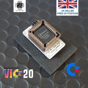May include: A close-up of a Winbond W27C512P-45Z chip on a small circuit board, set on a black foam pad. The text "VIC-20" and "commodore" are visible. The image also includes the text "Cece Tech Tools".