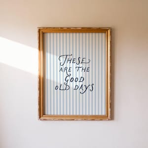 May include: A white ceramic mug with a black handle and the text "But First, Coffee" in a handwritten style. The mug is on a white surface. The mug is approximately 4 inches tall.