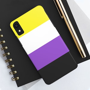 May include: A smartphone case featuring the non-binary pride flag design. The case is divided into horizontal stripes of yellow, white, purple, and black. The phone case is on a black notebook with a gold pen.