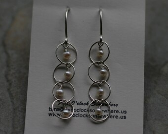 Loosely Linked II - Pearls and sterling rings on hand forged sterling ear wires