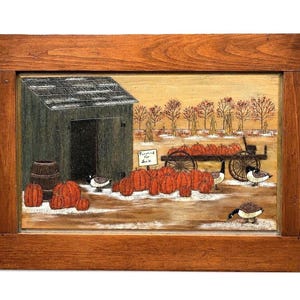 May include: A framed painting depicting a rural autumn scene with a dark shed, a wooden barrel, and numerous orange pumpkins scattered on the ground. A wagon filled with pumpkins sits nearby with a sign reading Pumpkins for Sale and geese.