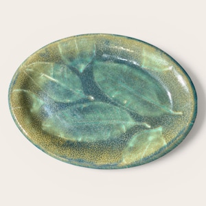 May include: A set of three ceramic mugs with a speckled, matte finish. The mugs are in shades of cream, light gray, and dark gray. Each mug has a simple, minimalist design, perfect for coffee or tea.