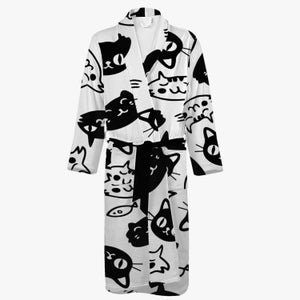 May include: A white bathrobe with a black and white cat print. The robe has a long sleeve and a tie belt.