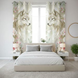 May include: Bedroom with a bed, two bedside tables, and a window with curtains. The curtains display a detailed illustration of a white wolf with pink and white floral accents. The room has a neutral colour palette with a light grey carpet.