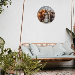May include: A clock featuring two Highland cows eating ramen noodles from a bowl. The clock has a white background with black Roman numeral hour markers and black hands. The cows are brown and white with black noses and hooves. The clock is hanging on a white wall above a light brown wicker swing bench with light blue cushions.