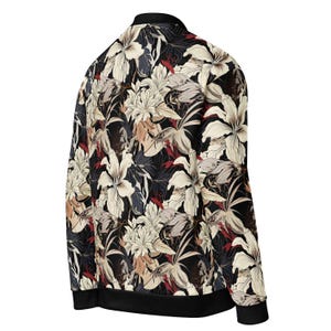 May include: A black bomber jacket with a floral print featuring white, red, and brown flowers on a black background.