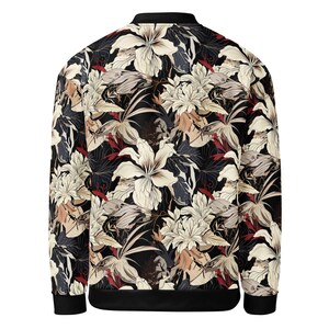 May include: A black bomber jacket with a floral print featuring white, beige, and red flowers on a black background.