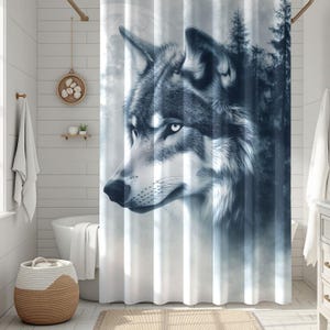 May include: A shower curtain featuring a detailed illustration of a wolf's head in shades of gray and blue. The wolf is set against a backdrop of a forest and a full moon, creating a serene and naturalistic scene.