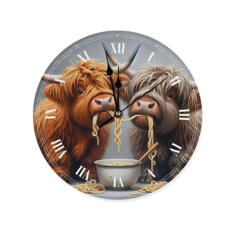 May include: A round clock with Roman numerals features two Highland cows eating noodles from a bowl. The clock has a grey background and the cows are brown and white.