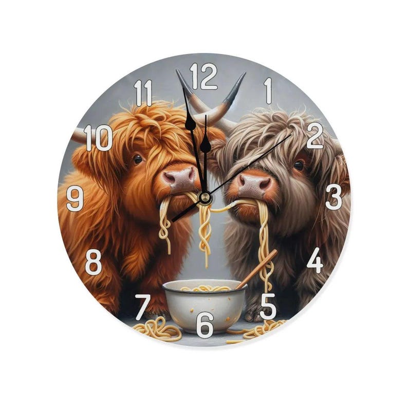 May include: A round clock with a white face and black numbers. Two brown and white Highland cattle are eating noodles from a bowl. The clock face has the numbers 1 through 12.