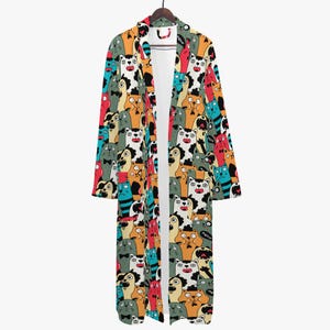 May include: A long, open-front robe with a colorful cat pattern. The robe features a variety of cartoon cat faces in shades of orange, blue, green, and red. The robe is hanging on a wooden hanger.
