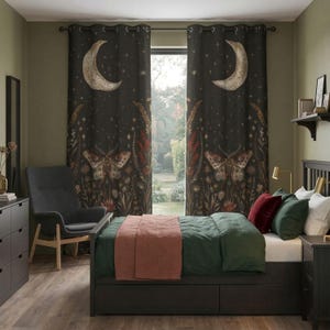 May include: Dark, patterned bedroom curtains with a celestial design. The curtains feature a large crescent moon, stars, and a moth illustration. The bedroom has a bed with green bedding and a pink throw, a gray chair, and a dark dresser.