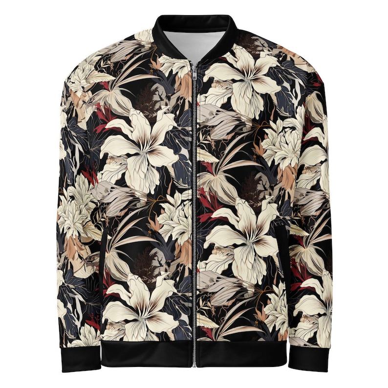 May include: A black bomber jacket with a floral print featuring white, beige, and red flowers. The jacket has a zipper closure and ribbed cuffs and hem.