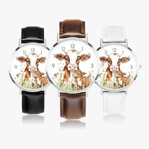 Könnte beinhalten: Drei Armbanduhren mit silberfarbenen Gehäusen und Lederarmbändern in Schwarz, Braun und Weiß. Jedes Zifferblatt zeigt eine Kuh- und Kälberillustration mit weißem Hintergrund und schwarzen Ziffern. Ein bezauberndes Accessoire.