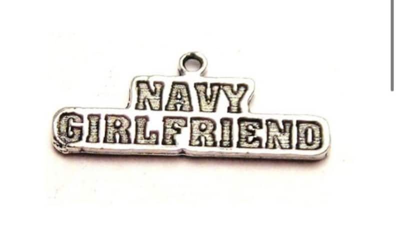 May include: Silver charm with the words "NAVY GIRLFRIEND" engraved on it.