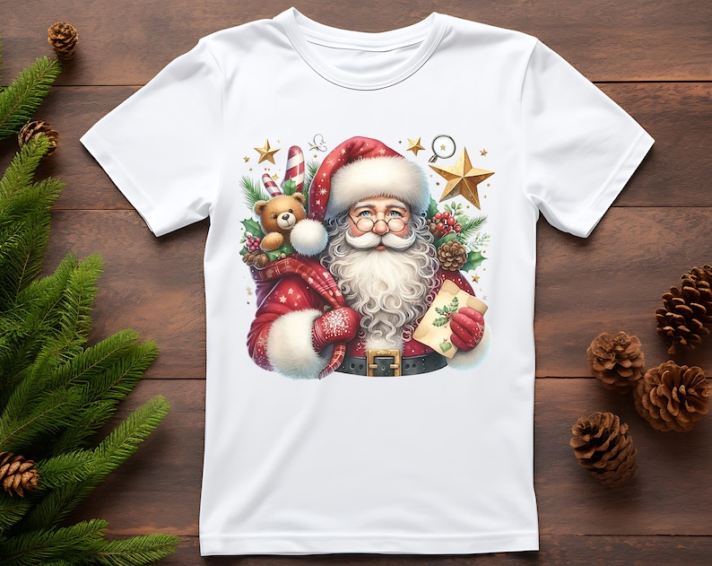 May include: White t-shirt with a colorful illustration of Santa Claus holding a teddy bear and a candy cane. The illustration is surrounded by stars and pine branches.