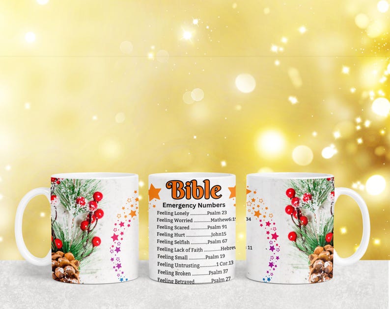 May include: Two white ceramic mugs with a winter holiday design. One mug has a Bible verse list with the title "Emergency Numbers". The list includes verses for feelings like loneliness, worry, fear, hurt, selfishness, lack of faith, smallness, untrusting, brokenness, and betrayal.