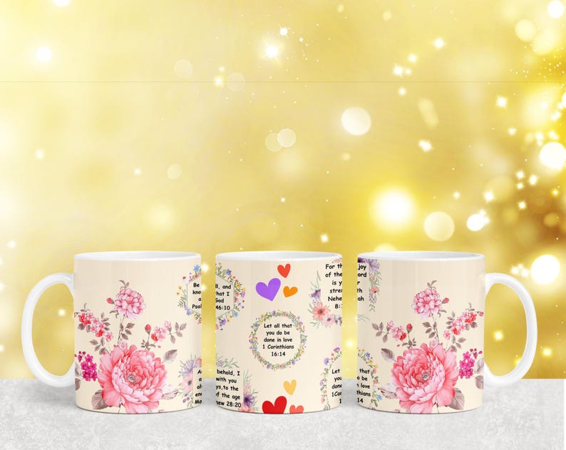 May include: Three white ceramic mugs with floral designs and inspirational quotes. The quotes are: "Let all that you do be done in love", "Be still and know that I am God", and "For the joy of the Lord is your strength".