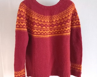 Hand knitted red nordic wool sweater with a orange patterned yoke
