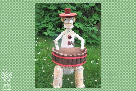 A hand-carved wooden clown with a built-in flower planter — Slavic folk craft meets garden weird, the kind of thing your neighbor will stare at.