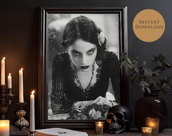 May include: A black and white portrait of a woman with dark hair and a flower in her hair. She is wearing a dark dress and a necklace. The portrait is framed in a dark wood frame.
