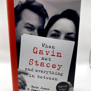 May include: A book titled "When Gavin met Stacey and everything in between" with a red spine. The cover shows a black and white photo of two people and the words "signed copy".
