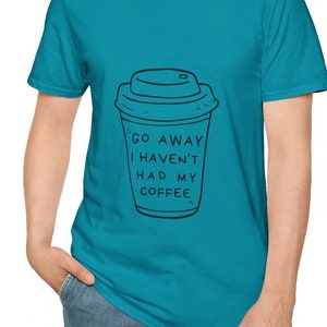 May include: A turquoise blue t-shirt with a black and white illustration of a coffee cup and the text "Go Away I Haven't Had My Coffee."