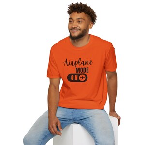 Orange t-shirt with black Airplane Mode ON design featuring a sliding switch graphic and plane icon.