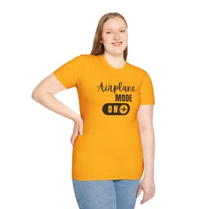 Gold t-shirt with black Airplane Mode ON design featuring a sliding switch graphic and plane icon.