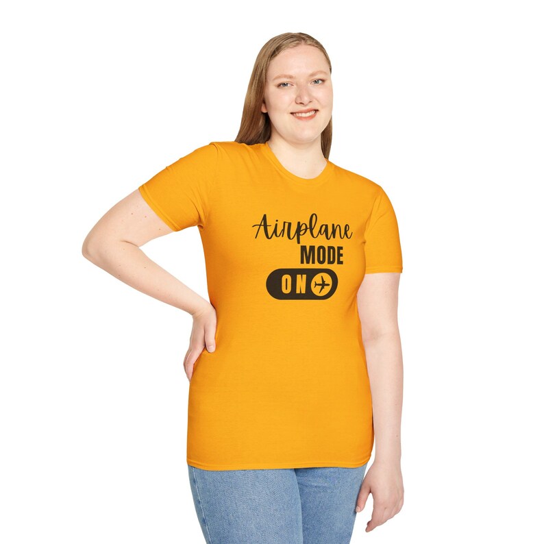 Gold t-shirt with black Airplane Mode ON design featuring a sliding switch graphic and plane icon.