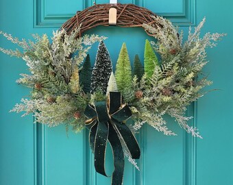 Winter season bottle brush tree wreath with an elegant velvet green bow