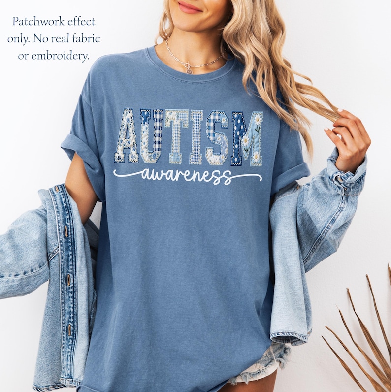 May include: Blue t-shirt with the word "AUTISM" in patchwork letters and the word "awareness" in a cursive font. The patchwork effect includes floral and gingham patterns. The text "Patchwork effect only. No real fabric or embroidery" is in the upper left corner.