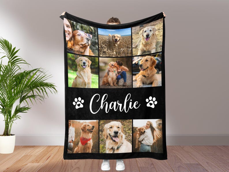May include: Black fleece blanket featuring a collage of golden retriever photos. The blanket has a black background with white paw prints and the name "Charlie" in a cursive font. The photos show dogs in various settings.