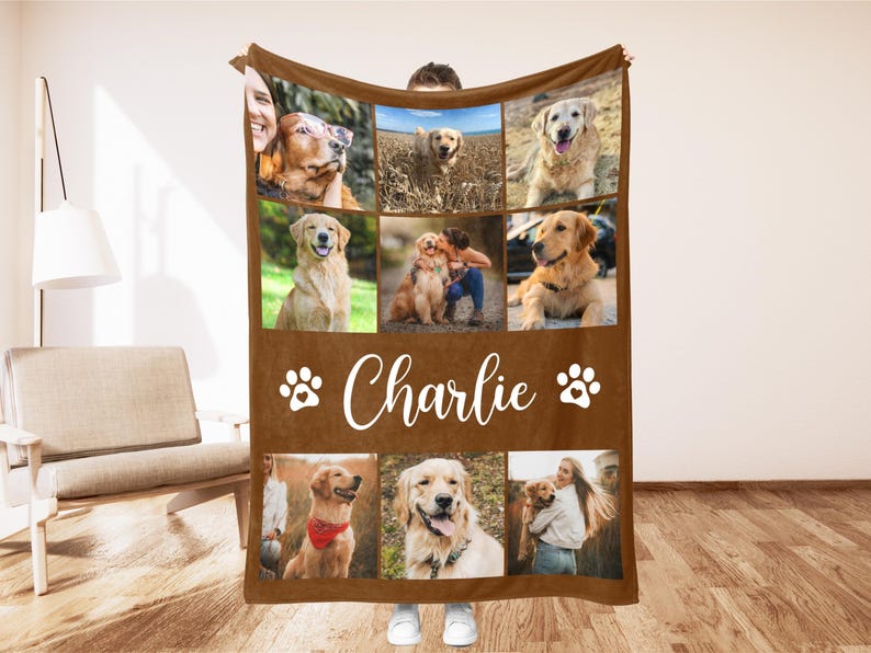 May include: A brown fleece blanket featuring a collage of photos of a Golden Retriever dog. The blanket has the name "Charlie" in white script, along with paw print designs. The photos show the dog in various poses.