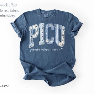 May include: A denim blue t-shirt with the letters "PICU" in a patchwork design. The letters are in a collegiate style, with floral and gingham patterns. Below the letters, the text reads "pediatric intensive care unit."