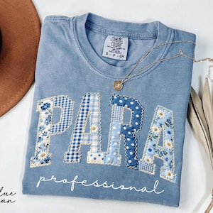 Blue Comfort Colors® t-shirt featuring large patchwork style PARA lettering with floral, gingham and polka dot fabric patterns in soft blue and white tones for school staff wear.