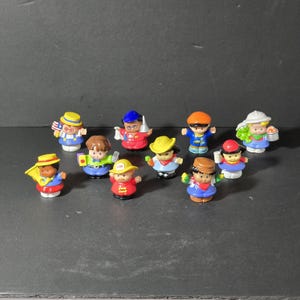 May include: A collection of ten small plastic figurines of people wearing different outfits and hats. The figurines are all about 2 inches tall and are made in a variety of colors, including red, blue, yellow, and green.
