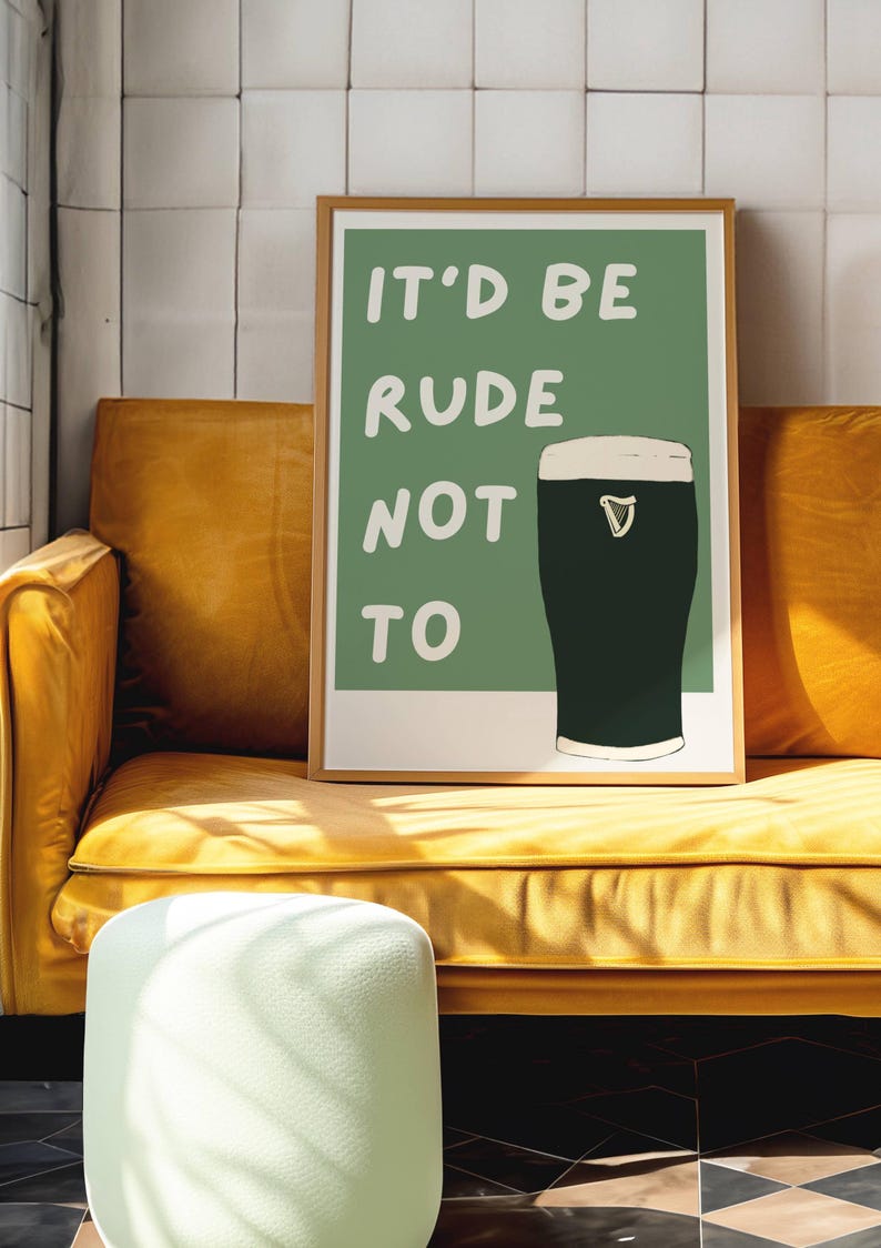 May include: A framed print with a green background and white text that reads "It'd be rude not to". A glass of dark beer with a white head is pictured to the right of the text.